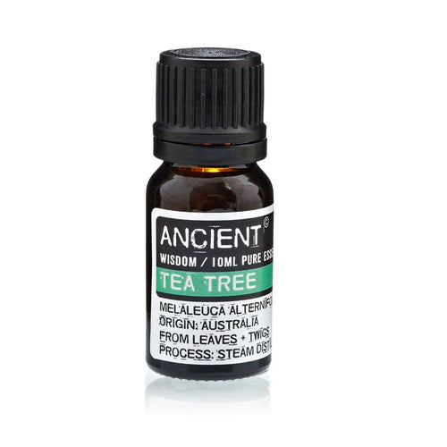Frasco de cristal ámbar con tapón negro y etiqueta de aceite esencial de árbol de té
