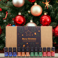 Set de aceites aromáticos navideños abierto con doce frascos delante de un árbol de Navidad con bolas doradas